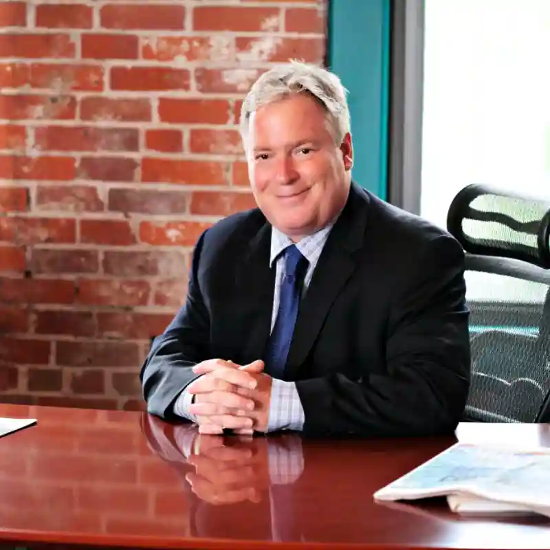 Robert L. Cummings sitting at his desk.